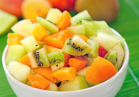 Bowl with fruit salad on tableの写真素材