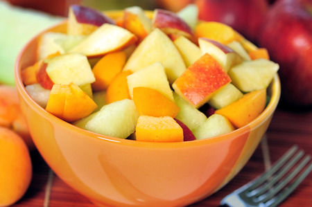 Bowl with fruit salad on tableの写真素材