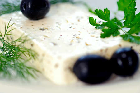 Cheese with herbs and oliveの写真素材