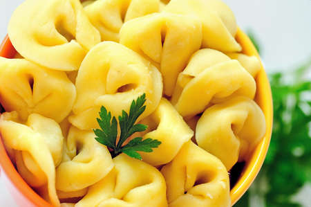 Bowl with tortellini on blue backgroundの写真素材