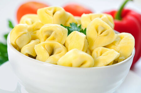 Bowl with tortellini on tableの写真素材