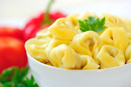 Bowl with tortellini on tableの写真素材