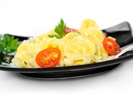 Plate with tortellini on whiteの写真素材