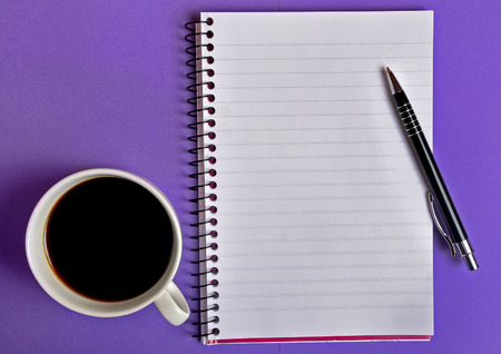 Notepad and coffee on backgroundの写真素材