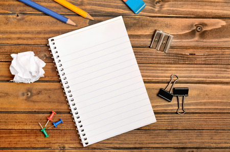 Empty notepad with office supply on table