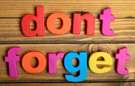 Colorful Dont Forget word on wooden tableの写真素材