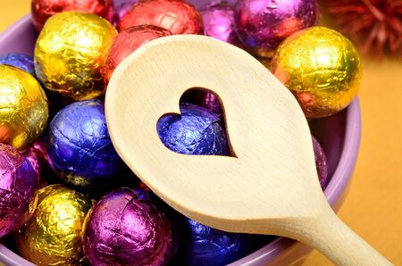 Wooden spoon with chocolate on table