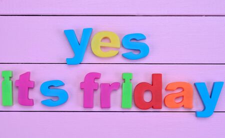 Words Yes it's friday on purple wooden tableの写真素材