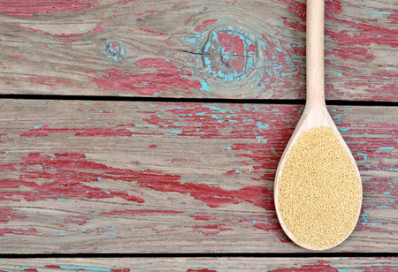 Amaranth seeds in spoon on wooden backgroundの写真素材