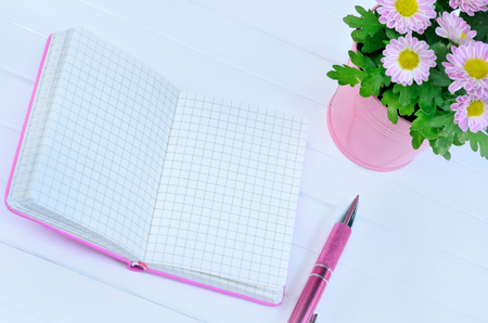 Empty notepad with pen on white tableの写真素材