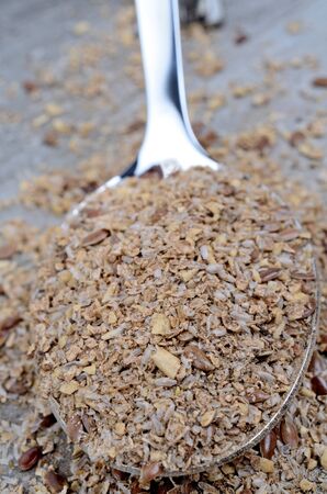 Spoon with bran on wooden tableの写真素材