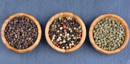 Different peppercorns in a bamboo bowlsの写真素材