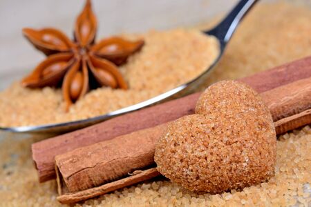 Spoon with sugar and anise star on wooden tableの写真素材