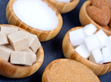 Sugar in a bowls on slate closeup