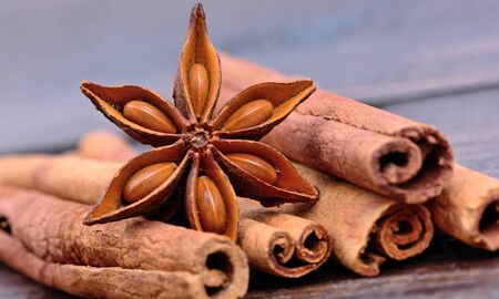 Anise star with cinnamon sticks on table