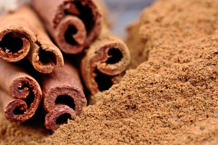 Cinnamon sticks with powder on tableの写真素材