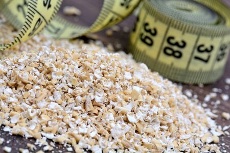 Oatmeal with centimeter on wooden tableの写真素材