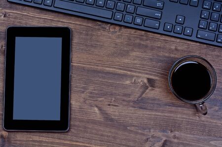 Digital pc with coffee cup and computer pc on deskの写真素材