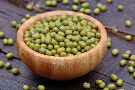 Bamboo bowl with mung beans on wooden table