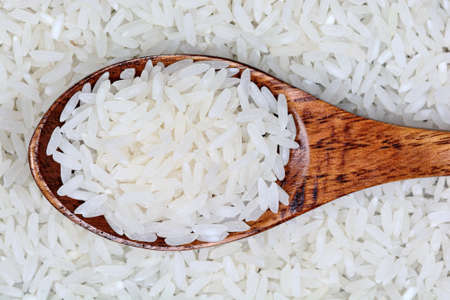 White rice in a wooden spoon close-upの写真素材
