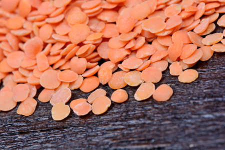 Group of red lentils on wooden tableの写真素材