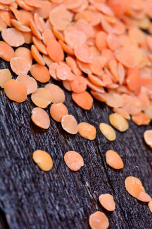 Many red lentils on wooden tableの写真素材