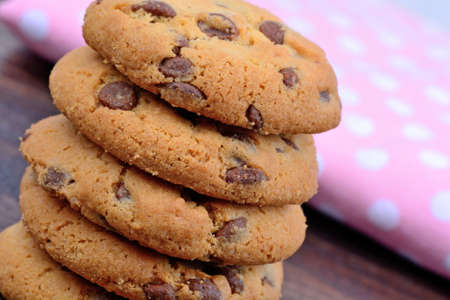Cookies and pink towel on wooden table