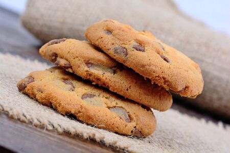 Delicious chocolate chip cookies on wooden table