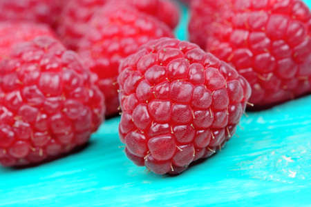 Raspberry on green  wooden table