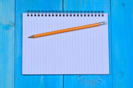 Empty notebook with pencil on desk close-up