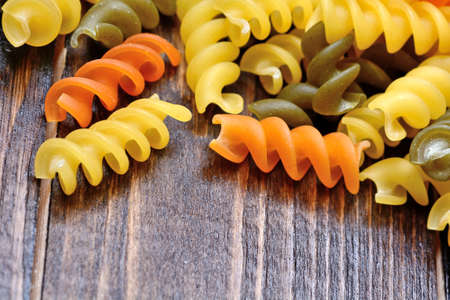 Colorful pasta on wooden tableの写真素材