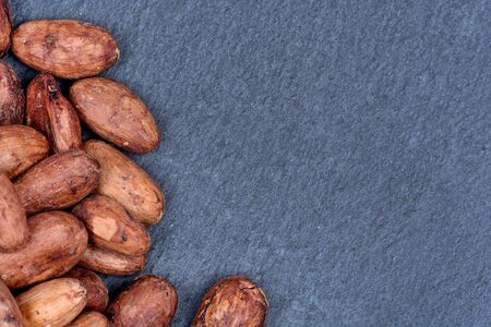 Heap of cacao beans on slate close-upの写真素材