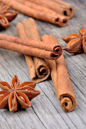 Cinnamon sticks with star anise on wooden table close-up