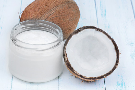 Fresh coconut oil in glassware on wooden tableの写真素材