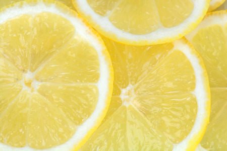 Background with citrus fruit of lemon slices close upの写真素材