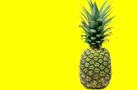 Close up of delicious pineapple on yellow backgroundの写真素材