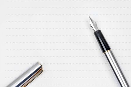 Fountain pen on a empty page of notepad close-upの写真素材