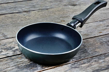 Close up of empty iron pan on a wooden tableの写真素材