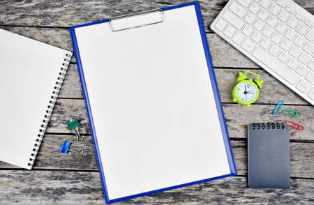 Clipboard with blank white paper with notepad and keyboard pc on desk