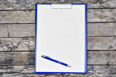 Close-up of empty notebook with many school objects on desk