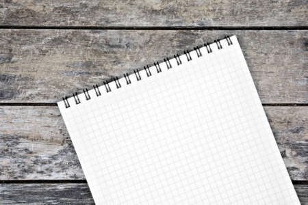 Close-up of empty notebook with many school objects on desk