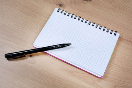 Empty notebook with pen, flowers and clock on an old wood tableの写真素材