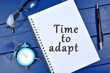 Close up of Time to adapt word on notepad pageの写真素材