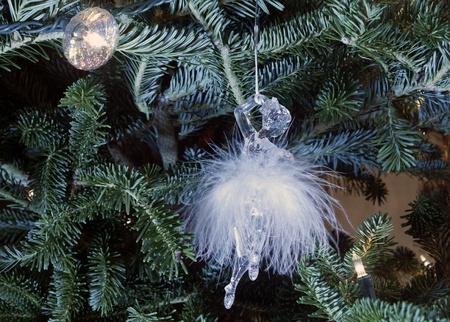 Ballerina ornament on a Christmas tree with lights. The ballerina is wearing a feather tutu. Closeupの写真素材