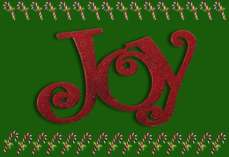 Joy and candy canes border on a green background の写真素材