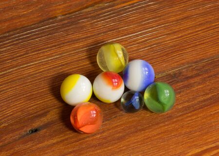 Multi-colored marbles on a tableの写真素材