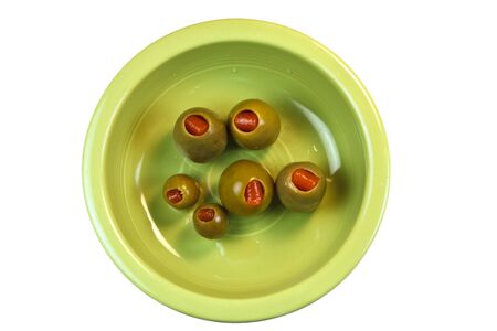 Green Olives in a green bowl isolated on a white backgroundの写真素材