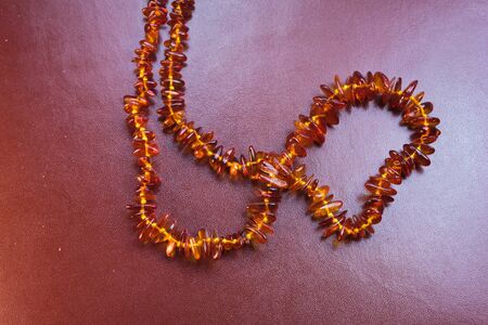 Amber necklace on brown leatherの写真素材