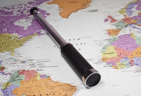 Monocular spy glass on a map of the world