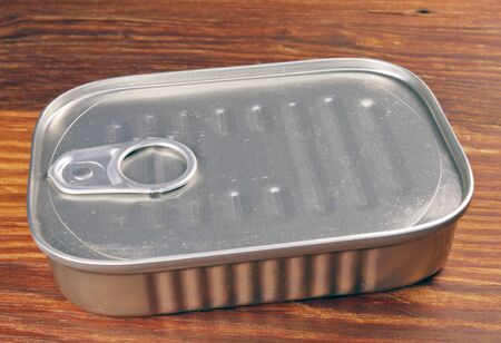 Closeup of a Sardine can on a wooden tableの写真素材